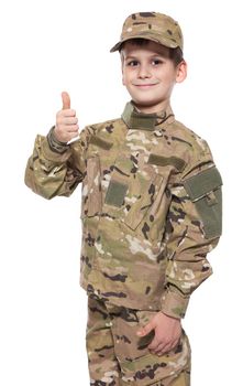 Saluting soldier. Young boy dressed like a soldier isolated on white