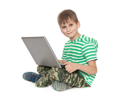 Boy holding a laptop isolated on white background