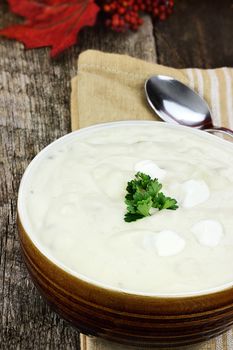 Creamy potato soup garnished with fresh parsley leaves.
