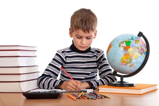 Cute schoolboy is writting isolated on a white background