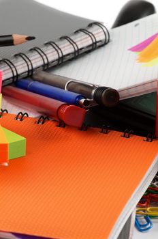 Office Suppliers with Pens and Ring Binder Notebooks close up