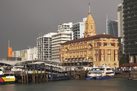 Historic Ferry Building and quay on the water front in Auckland, New Zealand