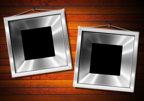 Two empty metallic frames on a old dark wooden wall
