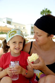 Healthy family. Mother and child eating apple and drinking water