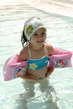 Happy child in a swimming pool