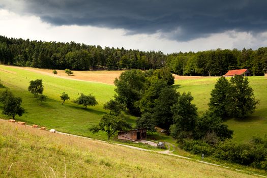 wooden farmhouse on summer Bavarian meadows