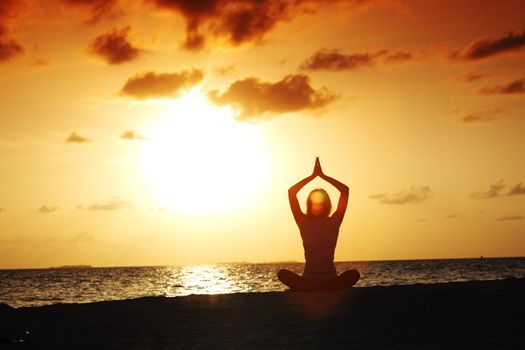 sunset yoga woman on sea coast