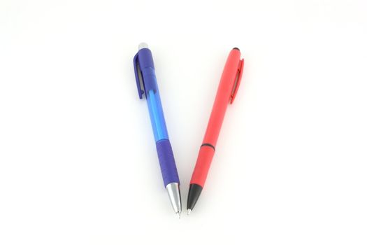 Blue and red pens over white