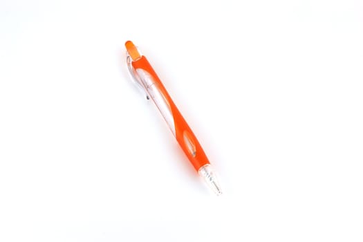 Orange ball-point pen over white