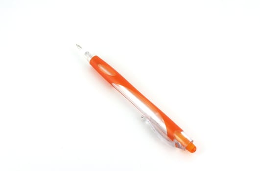 Orange ball-point pen over white