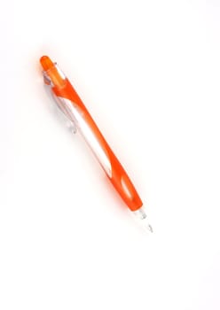 Orange ball-point pen over white