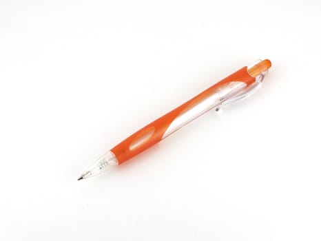 Orange ball-point pen over white