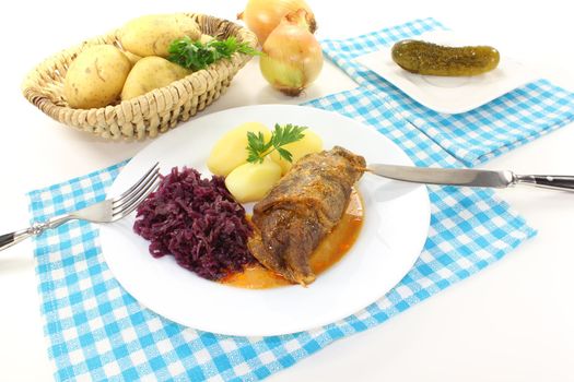 fresh stuffed Beef roulade with potatoes and red cabbage on a bright background