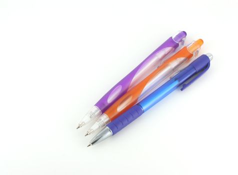 Three color pens over white