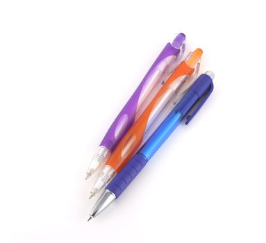 Three color pens over white