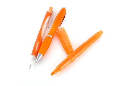 Orange pens and felt-tip pen over white