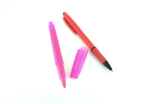 Red pen and pink felt-tip pen over white