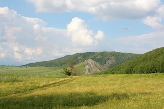 Beautiful summer landscape with mountains. Blue sky with clouds.