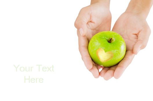 female hand and green apple with  heart shape on white background