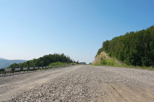 Summer landscape. Stone road on the mountains. 