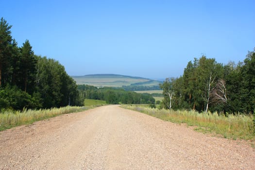 Summer landscape. Track across the mountains.