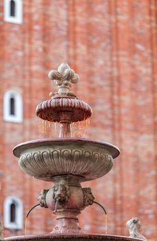 A traditional fountain runs with wine to celebrate the Venice Carnival in San Marco Square in Venice,Italy.