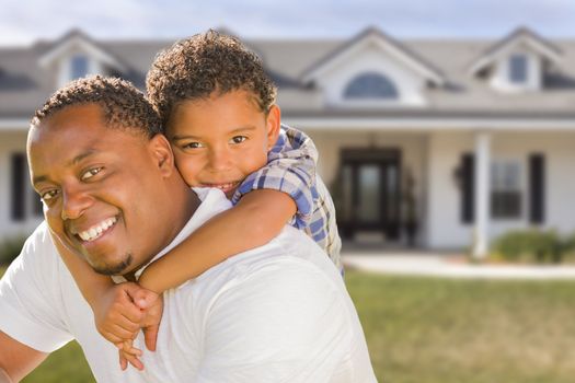 Happy Playful African American Father and Mixed Race Son In Front of House.