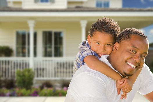 Happy Playful African American Father and Mixed Race Son In Front of House.
