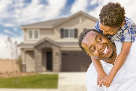 Happy Playful African American Father and Mixed Race Son In Front of House.