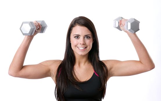 Sexy fitness instructor working out with free weights 