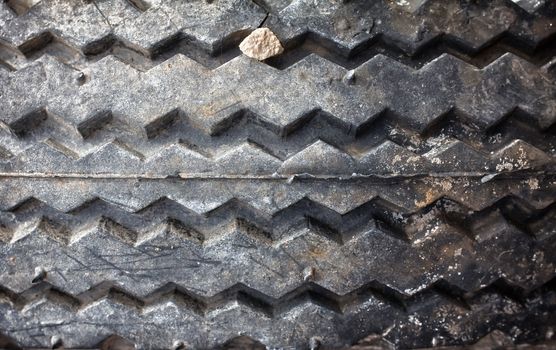 A worn bias ply tire with signs of age.