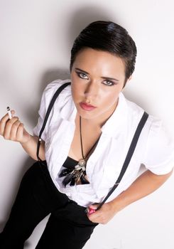 An androgynous person smokes a cigarette 