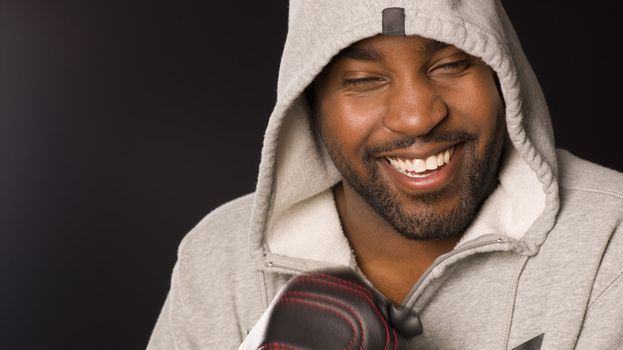 A boxer laughs with his eyes closed