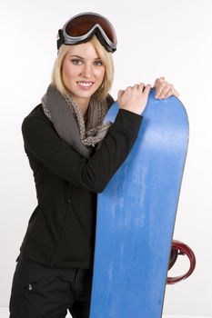 A Beautiful Blonde Woman poses with her Snowboard