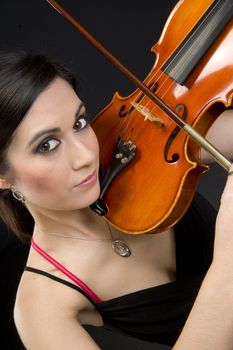 A beautiful woman holds a beautiful Violin