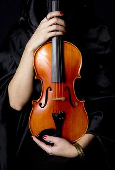 A robed figure holds a beautiful Violin