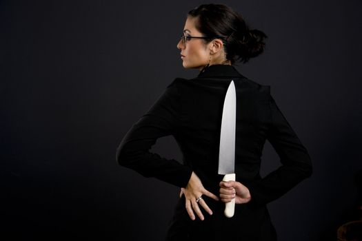 Pretty Woman holds a large knife behind her