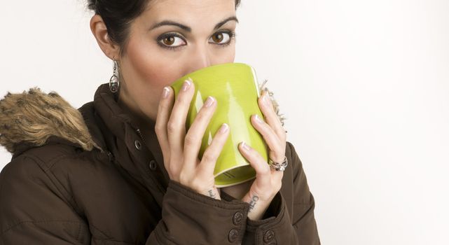 A beautiful woman warms up with a mug of Java