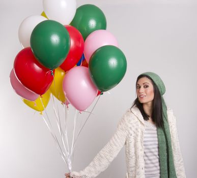 Common woman holds a bunch of balloons