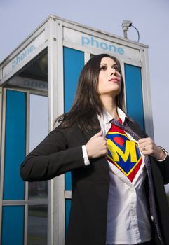 A Woman shows her Super Mother Uniform underneath her street clothes outside a phone booth