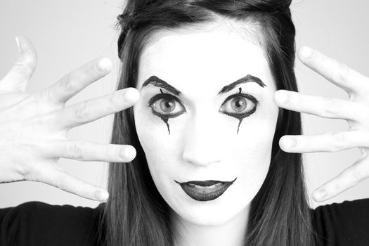 Pretty female Mime Looking through her fingers