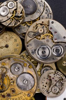 Time Pieces in a pile partly disasembled 