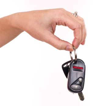 A womans hand holds car keys