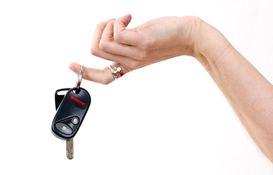 A hand holds car keys