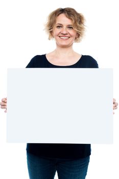 Casual lady displaying blank white billboard isolated on white background