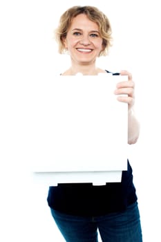 Casual woman holding open pizza box in front of camera