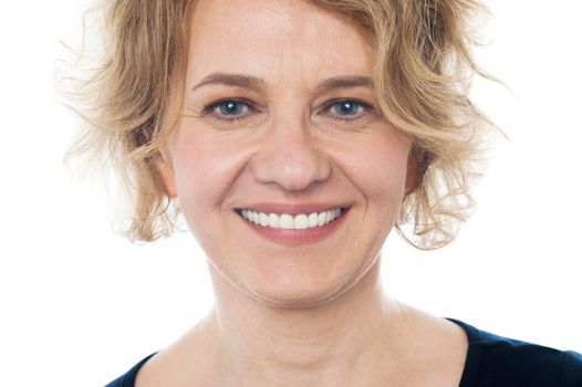 Closeup of smiling aged woman against white background