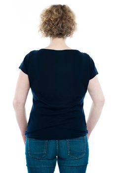Rear view of curly haired stylish caucasian woman isolated on white background