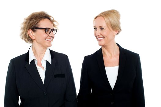 Aged corporate women looking at each other, business concept