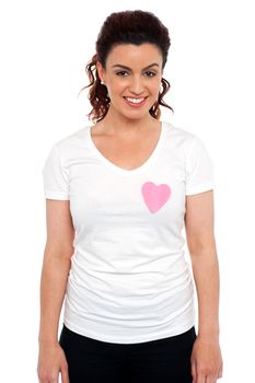 Woman with pink paper heart on her t-shirt. Love concept